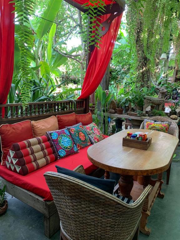An open-air sitting area surrounded by dense tropical planting.