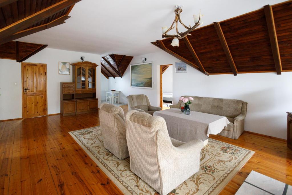 a living room with a table and chairs at Holiday home Jarzębinowa 9 in Rowy