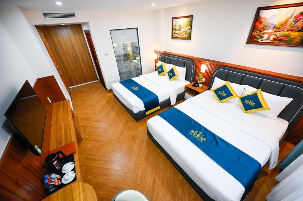 מיטה או מיטות בחדר ב-PLUS VUNG TAU HOTEL