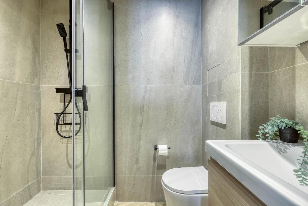 a bathroom with a shower and a toilet and a sink at New and Designed Studio well Equipped - Heart of Paris 2 in Paris