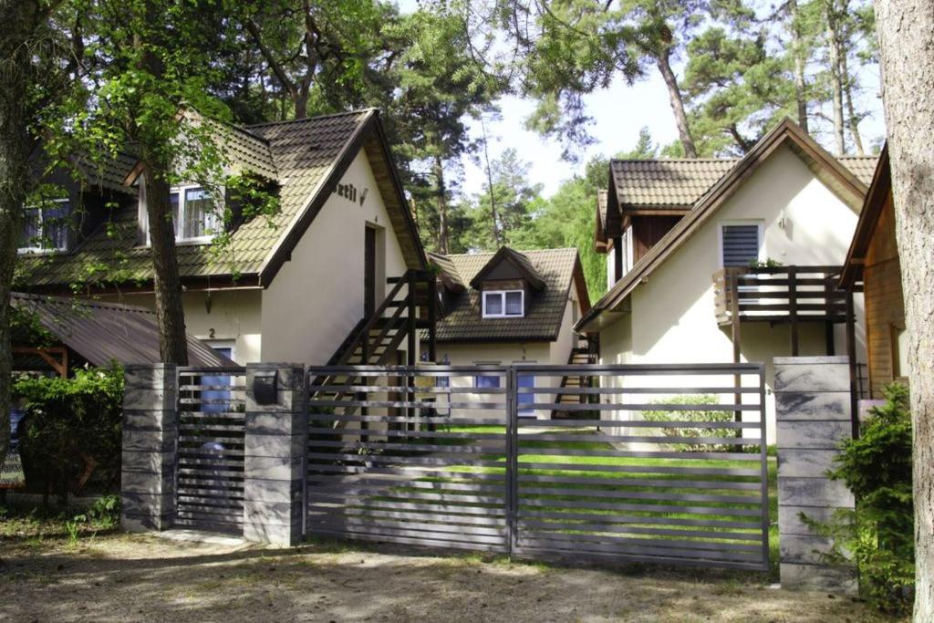 a house with a fence in front of it at O.W.Sztil in Pobierowo