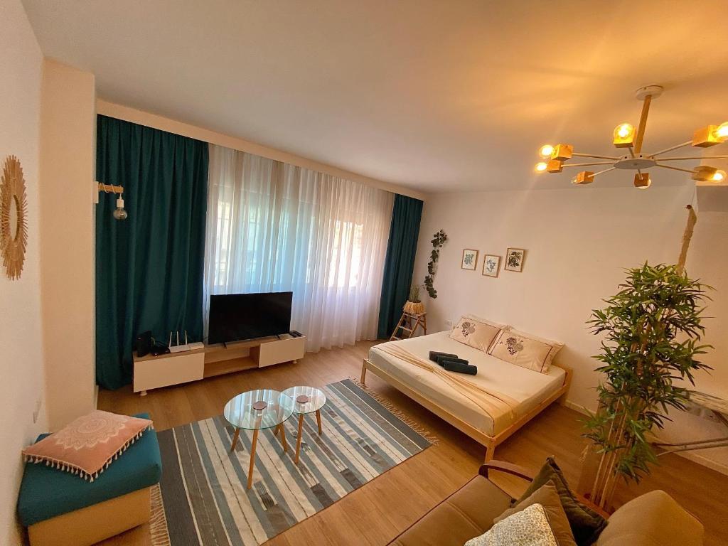 a living room with a couch and a tv at Studio Flat in the City Center in Tirana