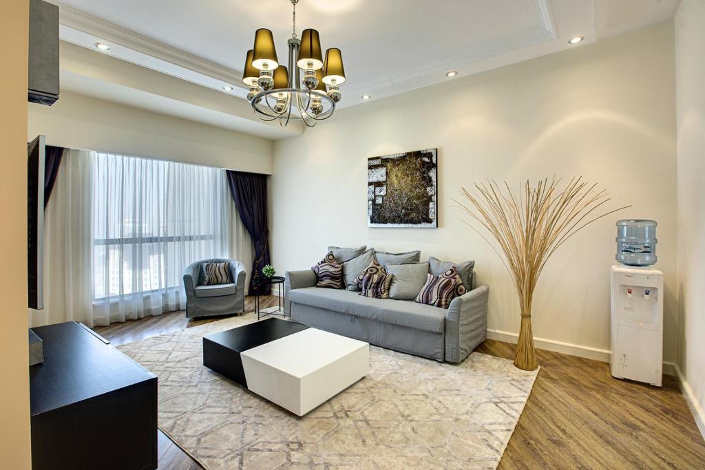 a living room with a couch and a table at Stunning sew view apartment in JBR in Dubai