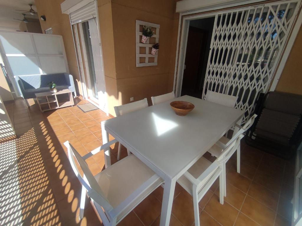 a white table and chairs in a living room at Apartamento con piscina y cerca de la playa in Canet de Berenguer