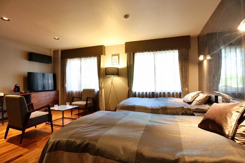 Postel nebo postele na pokoji v ubytování Hakuba Park Hotel