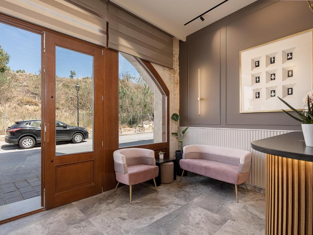 A bed or beds in a room at Ethos Suites