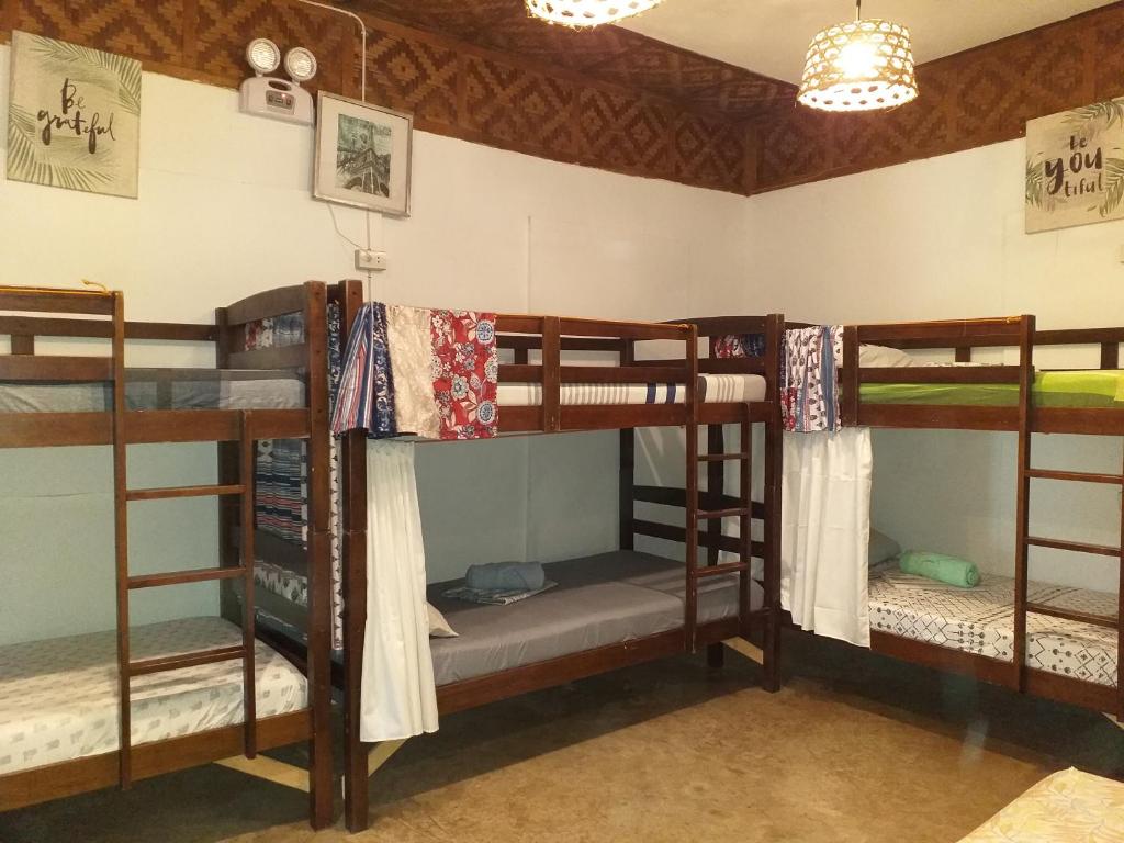 a group of bunk beds in a room at Paraiso Hostel Moalboal in Moalboal