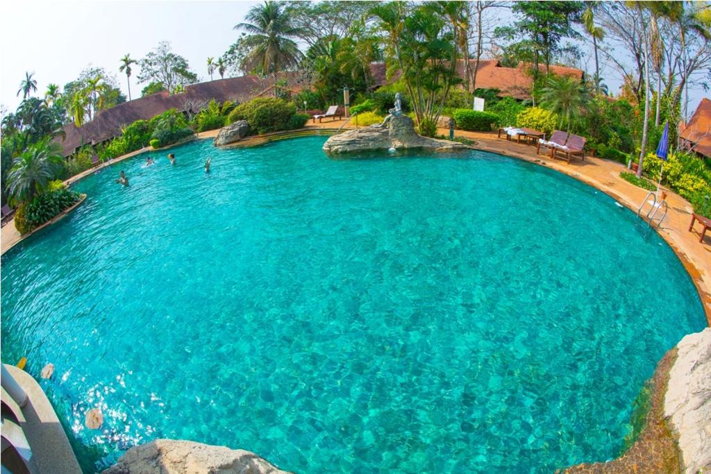 a large pool of blue water with people in it at Golden Pine Resort and Spa in Ban Du