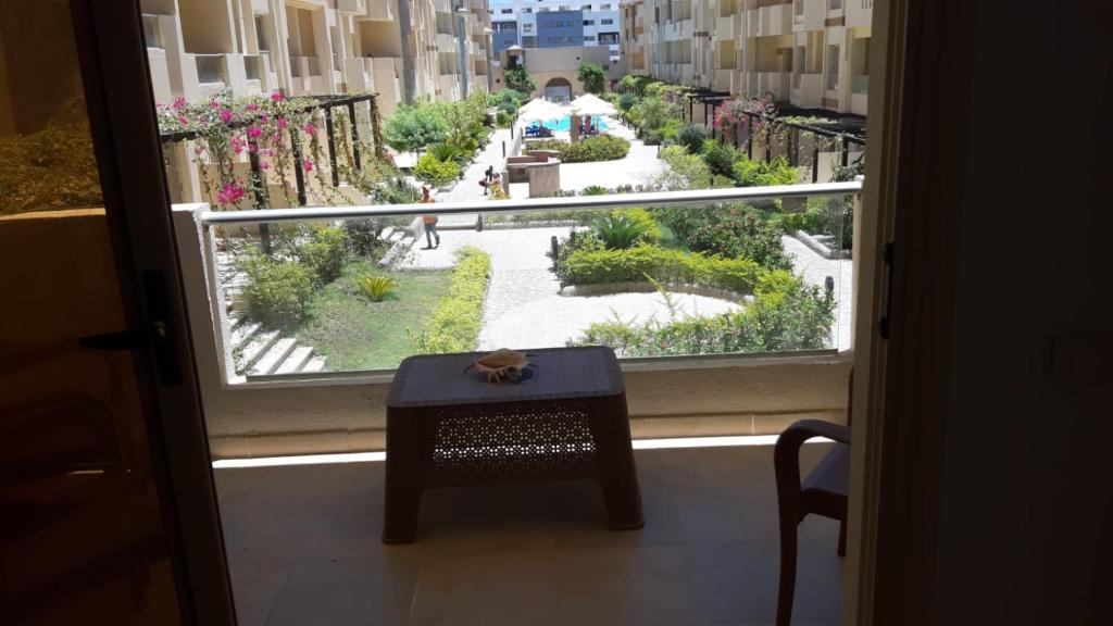 a window with a table and a view of a courtyard at casa di nonna in Hurghada