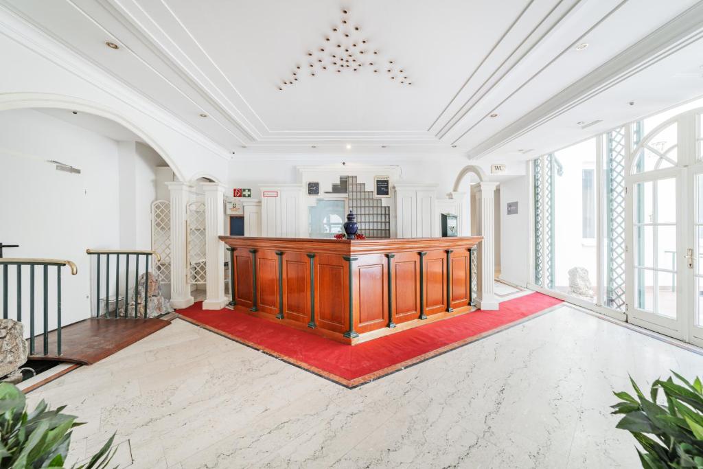 an empty room with a wooden podium in a room with windows at Self-Check-In Hotel Adlon in Vienna