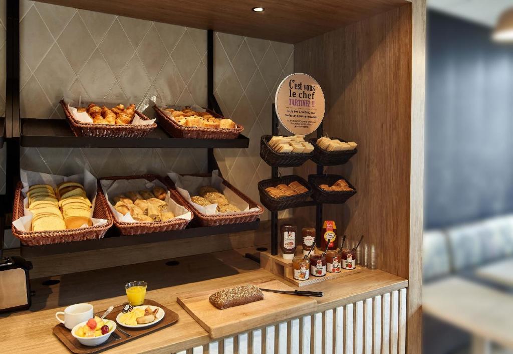 a bakery with pastries and other food items on display at B&B HOTEL Perpignan Centre in Perpignan