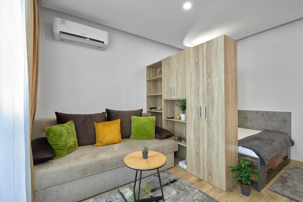 a living room with a couch and a bed at Monopoly Apartments - 9 in Burgas