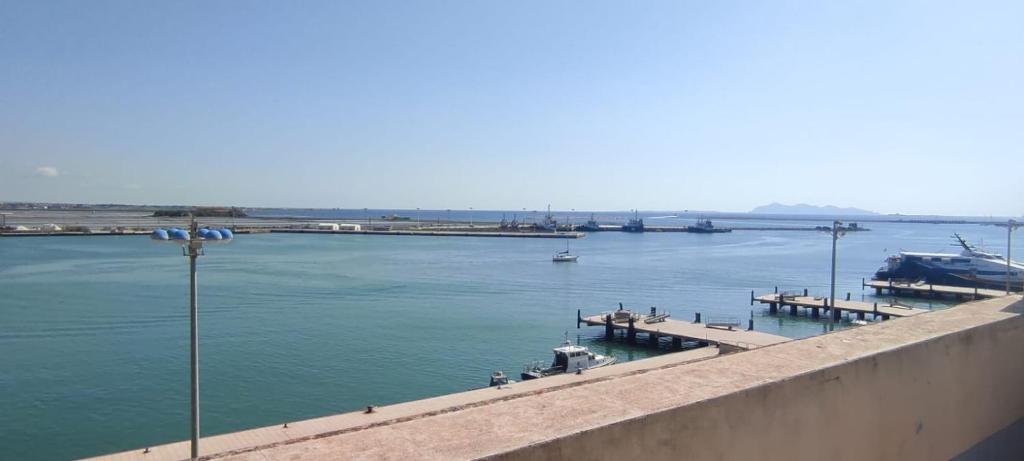a large body of water with a dock and a boat at The twins Rooms in Trapani 1 in Trapani