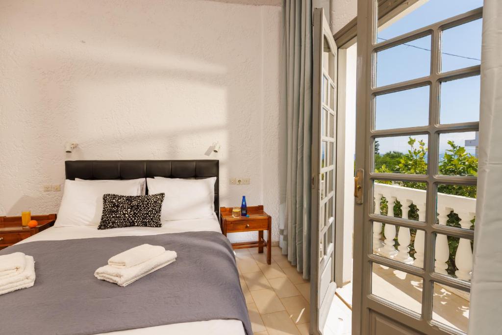 a bedroom with a bed with towels on it at Kings Hersonissos Hotel & Apartments in Hersonissos