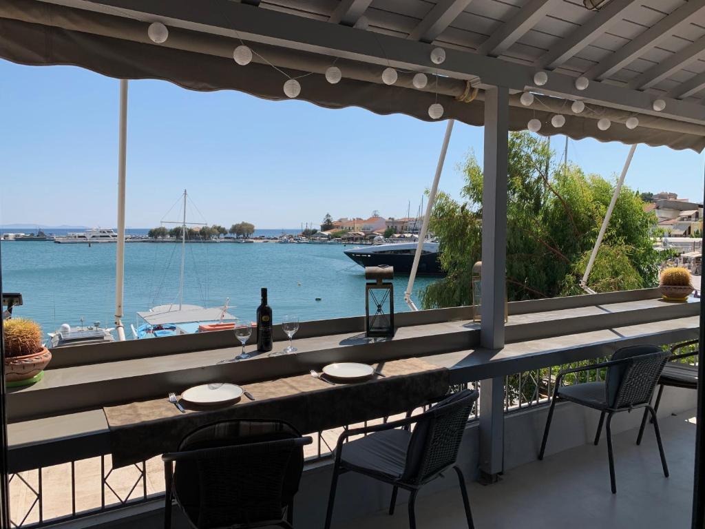 a table on a balcony with a view of the water at Pythagorion Harbour Residence in Pythagoreio