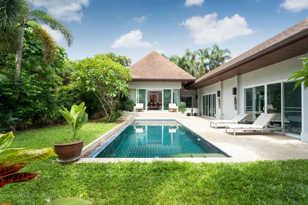 a swimming pool in the backyard of a villa at Balinese Style 3BR Villa Morning Forest, Nai Harn in Rawai Beach