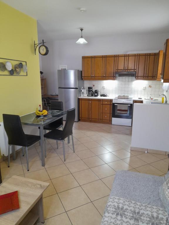 a kitchen with a table and chairs in a kitchen at SummerAndros Windmill in Andros