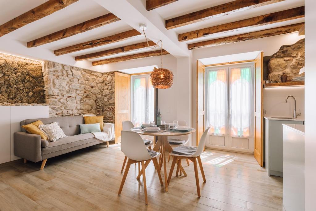 a living room with a table and a couch at Casa do Tio Farinha by RNvillage in Sesimbra