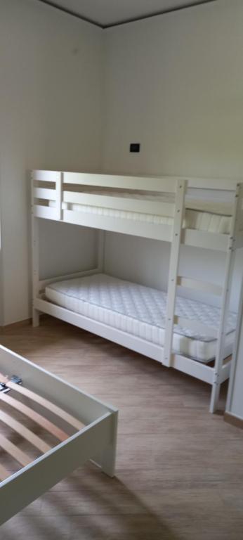 two white bunk beds in a room at Agropoli Rooms in Agropoli