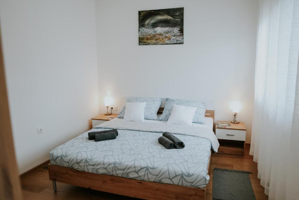 a bedroom with a bed with two pillows on it at Apartman Nikola in Gospić