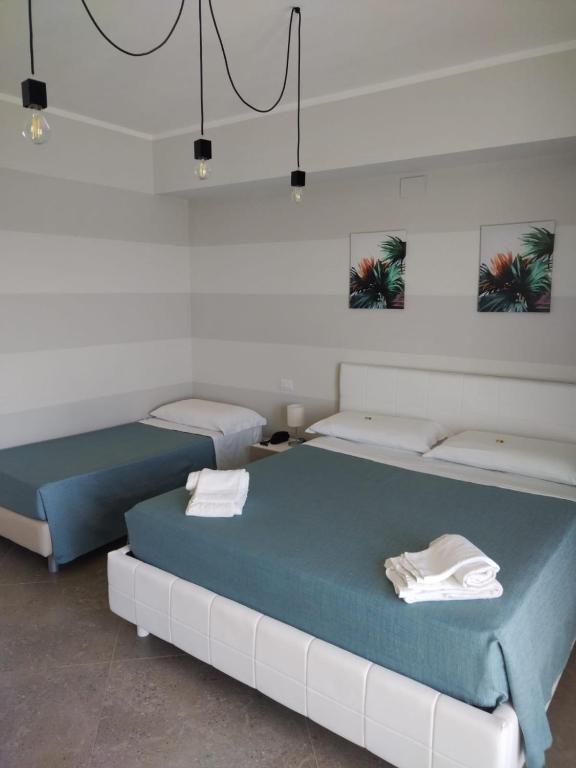 Postel nebo postele na pokoji v ubytování Sand Hotel