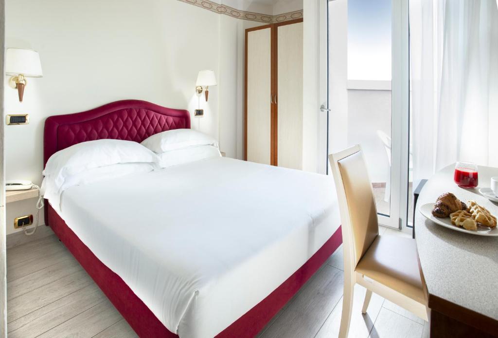 Postel nebo postele na pokoji v ubytování Hotel Bikini
