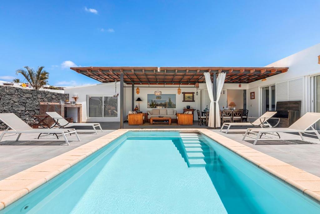 a swimming pool in the backyard of a house at Villa Patos in Playa Blanca