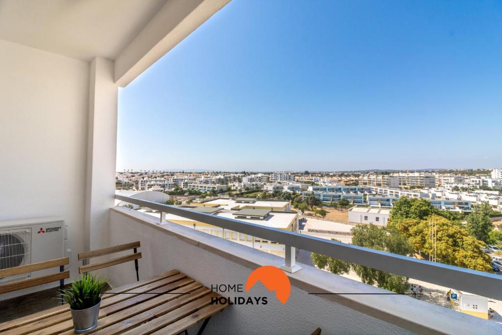 a balcony with a bench and a view of the city at #048 Sea and City view with Pool, AC in Brejos