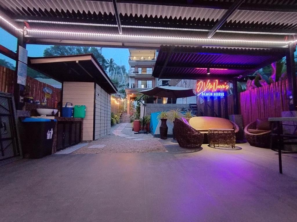 a building with purple lights on a sidewalk at D Villa Nueva's Beach House in Lobo