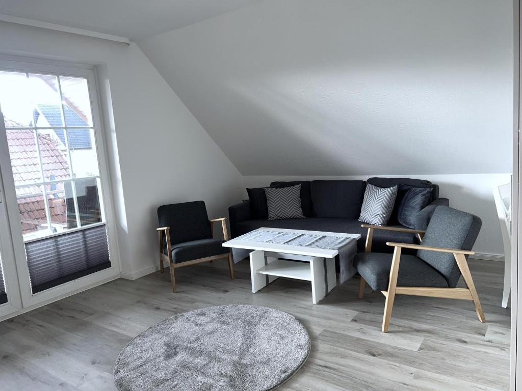 a living room with a couch and a table at Appartementhaus Müller in Niendorf