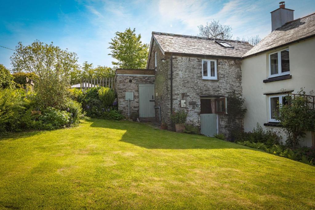 an exterior view of a house with a yard at The Snickett in Combe Martin