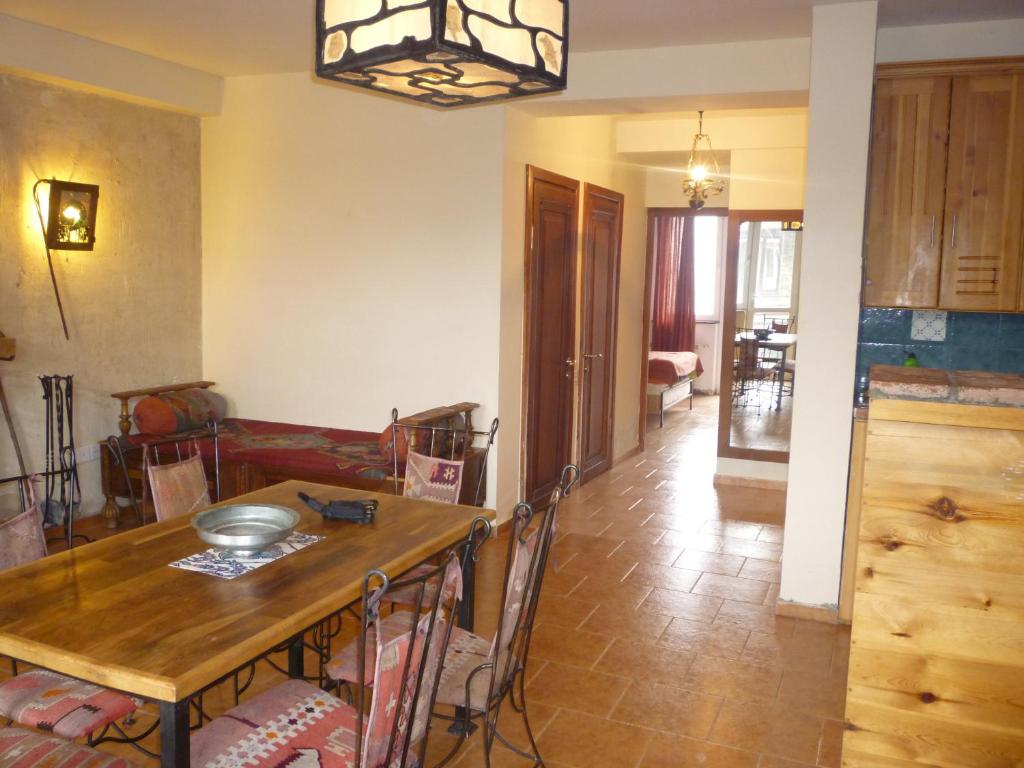 a kitchen and dining room with a table and chairs at Gudauri Vano Apartments in Gudauri