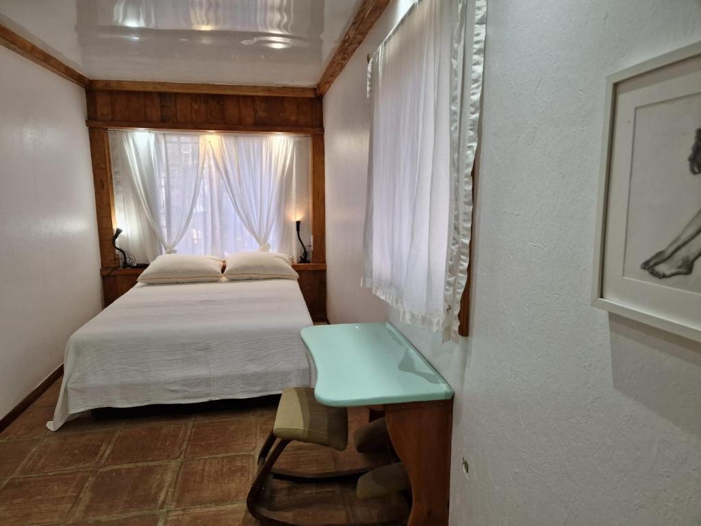 a small bedroom with a bed and a window at Bolonia Beach Campus in Tarifa