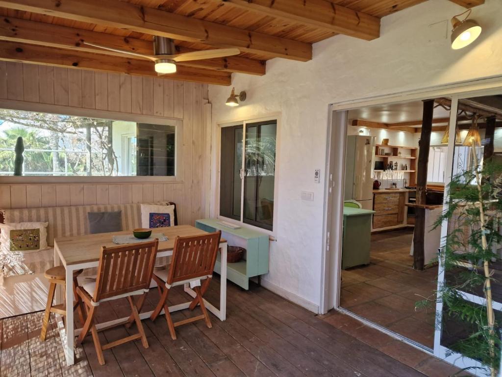 a screened in porch with a table and chairs at Bolonia Beach Campus in Tarifa