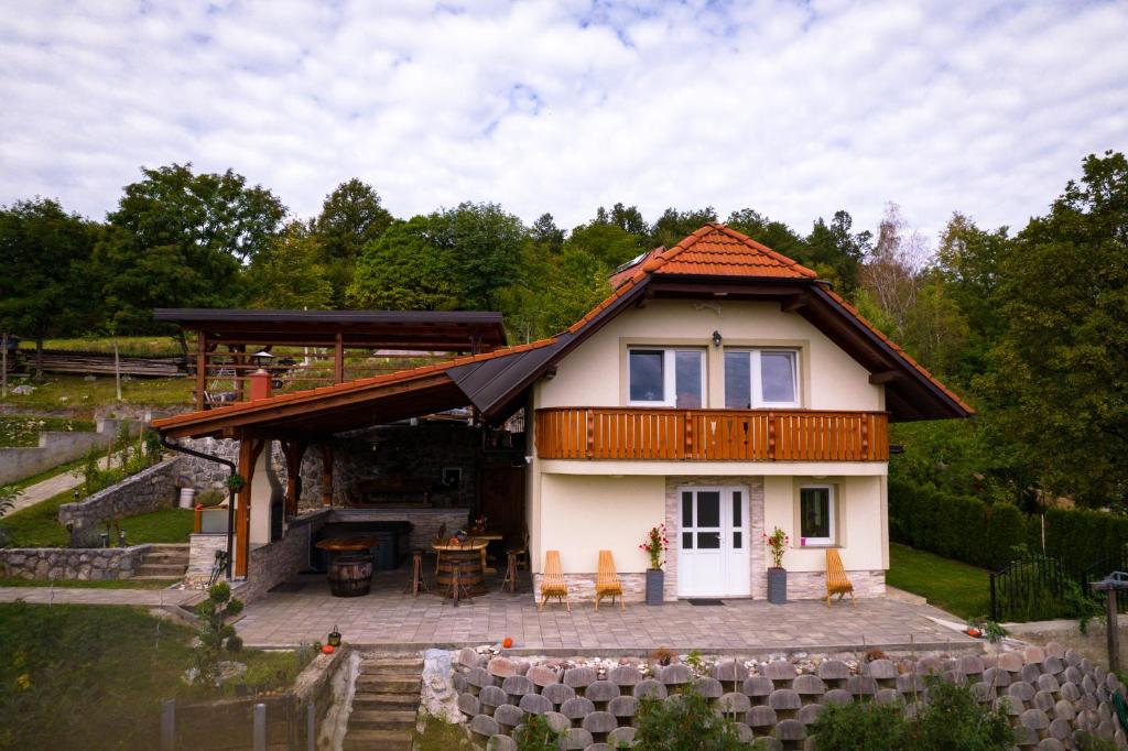 a small house with a porch and a patio at Vineyard cottage Na hribu in Dvor