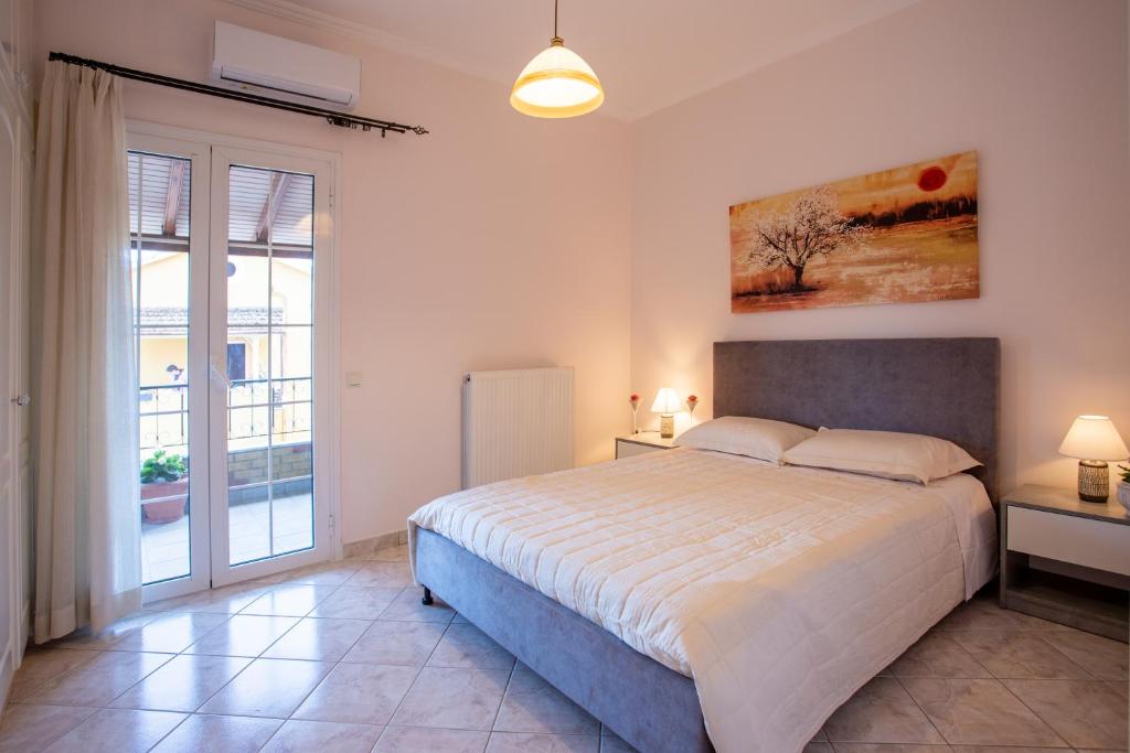 Un dormitorio con una cama grande y una ventana en Natali Home, en Kanálion