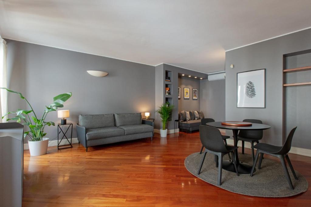 a living room with a couch and a table at Attico in Piazza Duomo in Milan