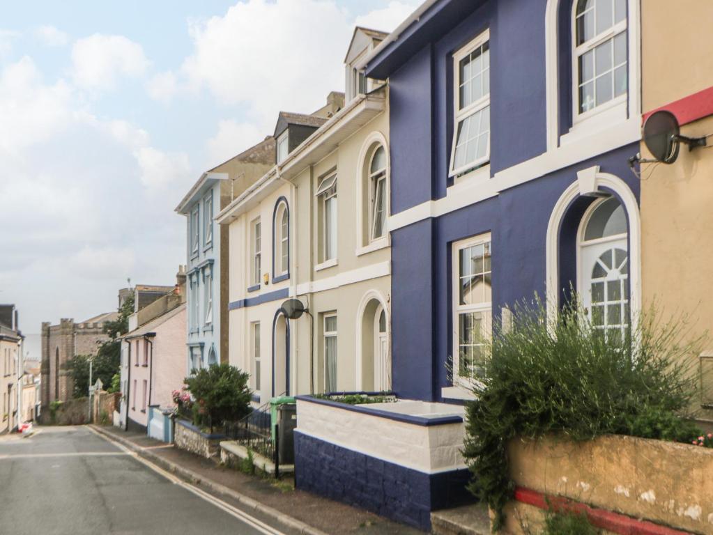 a row of colourful houses on a street at 27 Exeter Street in Teignmouth