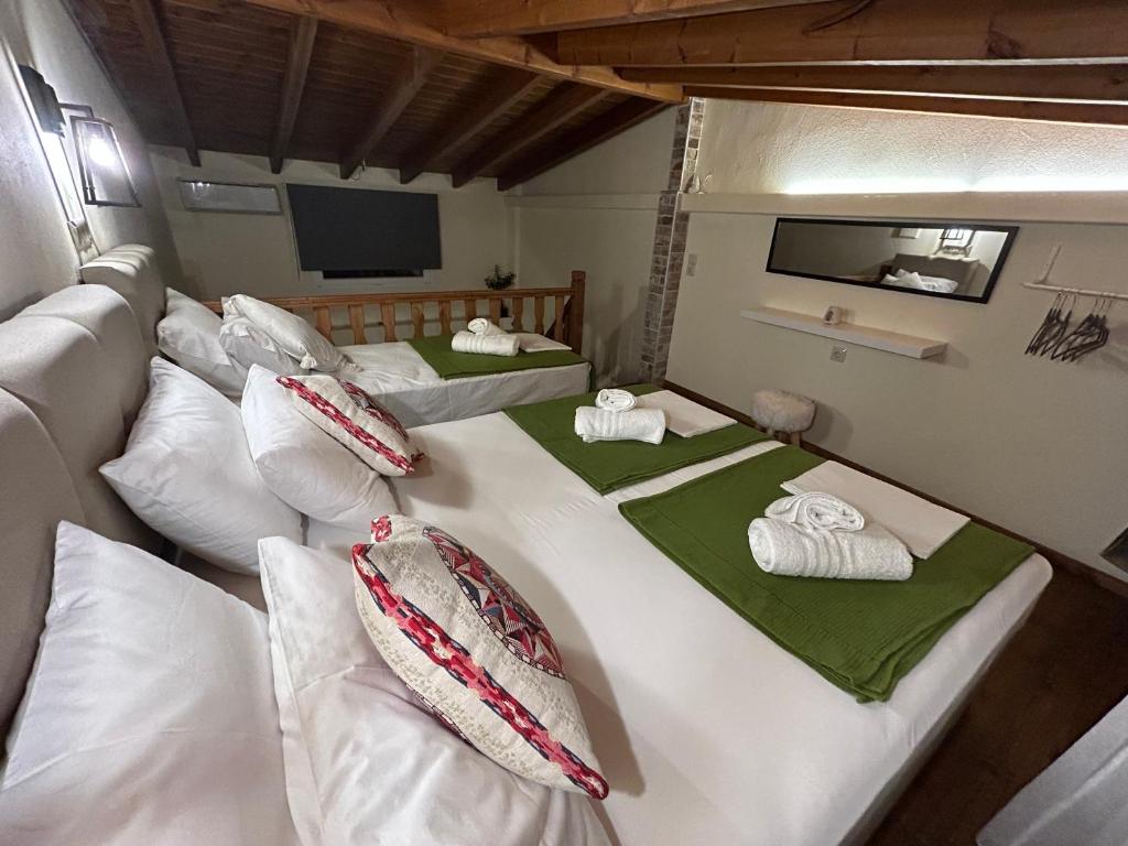 a room with two beds with towels on them at Green Olive Studios 2 in Áyios Mámas