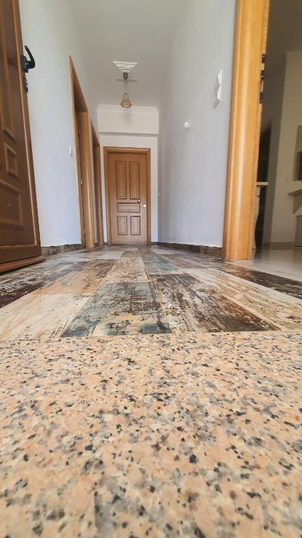 an empty room with a door and a rug on the floor at Mihal Suites in Sarandë