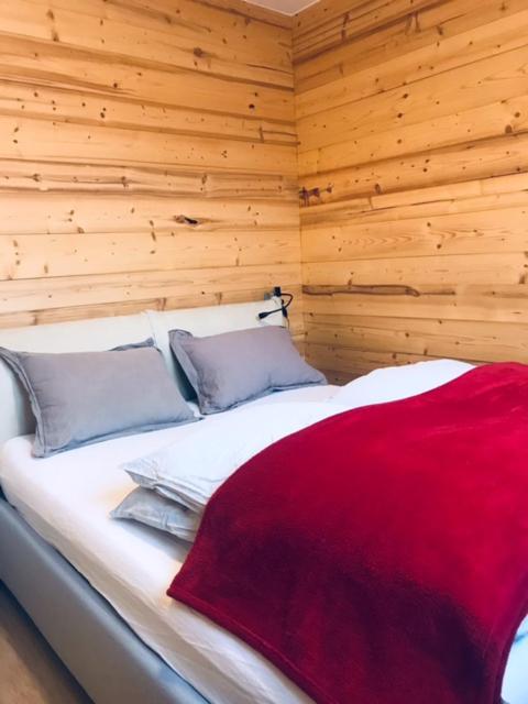 une chambre avec un lit avec une couverture rouge dessus dans l'établissement Aiguille Rouge, à Chamonix-Mont-Blanc