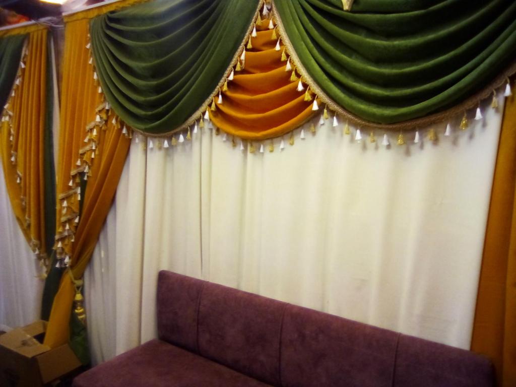 a stage with a curtain and a couch at BORDO SUİTE HOTEL in Trabzon