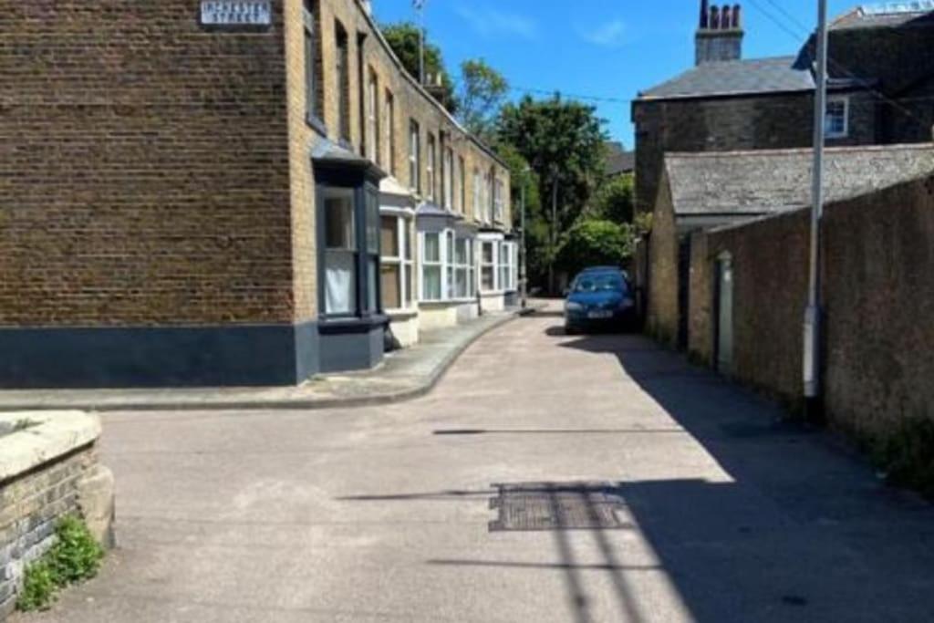 a street with a car parked next to a brick building at Balmoral Place, Ramsgate - 5 mins walk to Beach in Kent