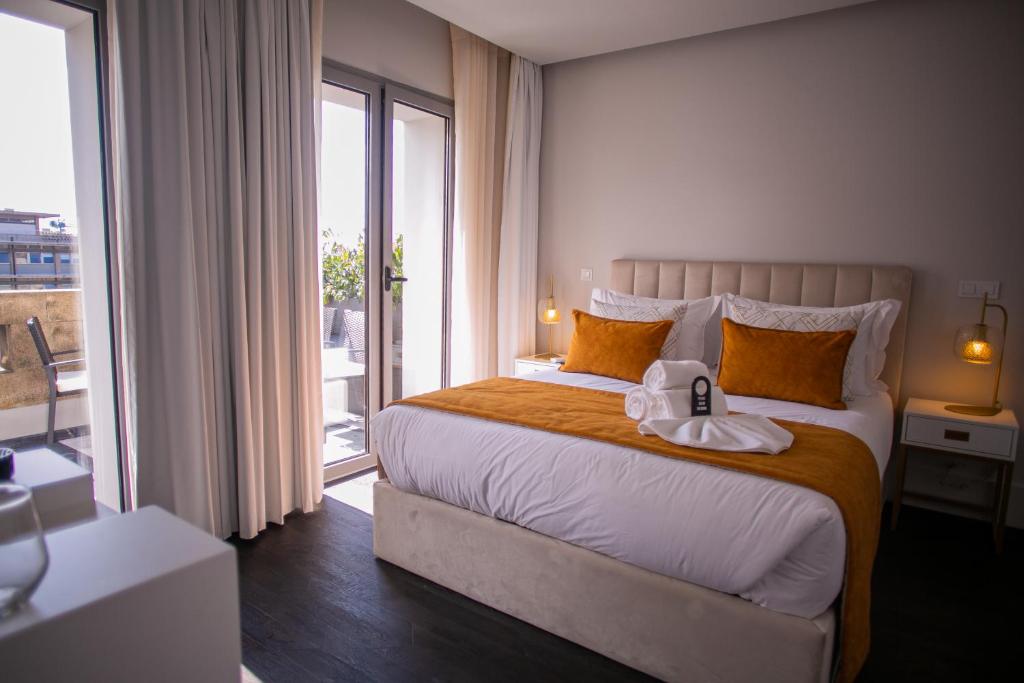 a bedroom with a bed with a towel on it at 262 Boutique Aliados in Porto