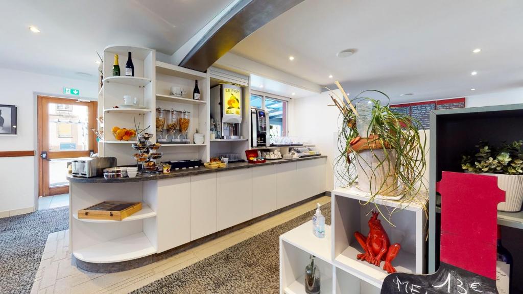 a kitchen with white cabinets and a counter at Cour Du Tonnelier in Bouxwiller