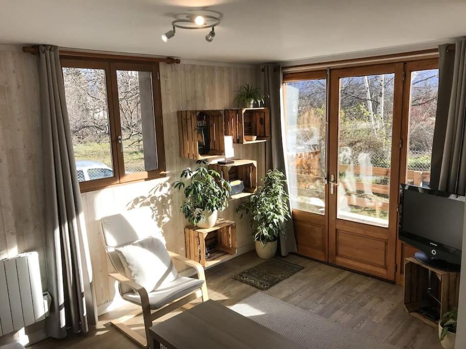 - un salon avec une porte coulissante et une télévision dans l'établissement Appartement La Maison de UR - Cerdagne, à Ur