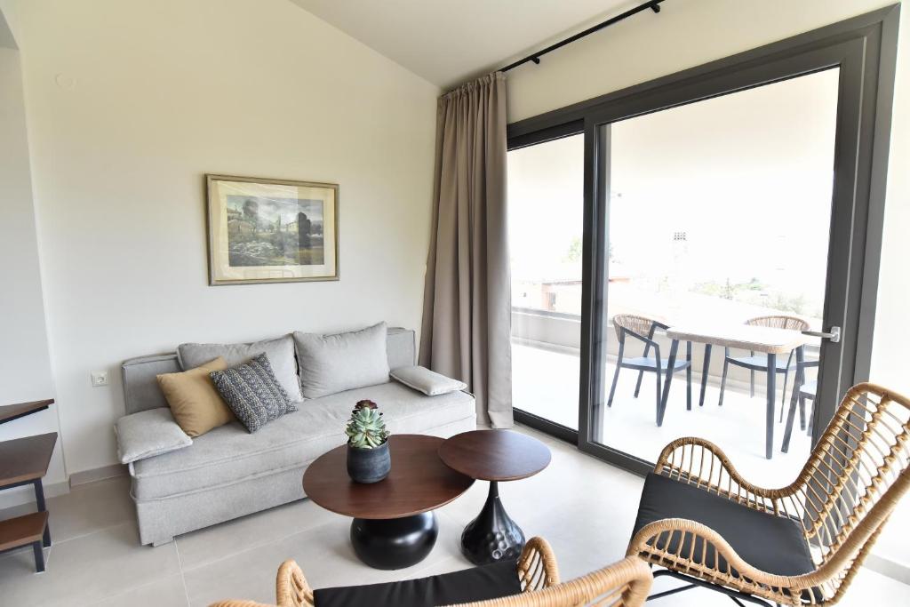 a living room with a couch and a table at Welcome Inn in Paleo Tsifliki
