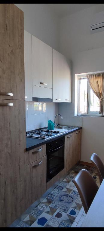 a kitchen with white cabinets and a stove top oven at Casamare in Torre Forte