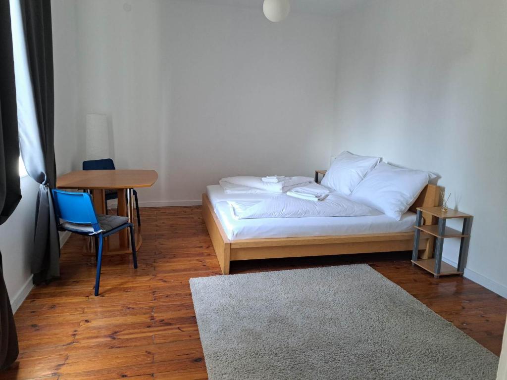 a bedroom with a bed and a table and a chair at Tarcal Apartman in Tarcal