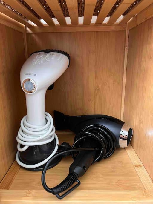 a hair dryer and a lamp sitting in a room at Paris Home in Boulogne-Billancourt